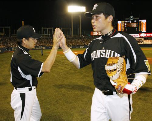 和田監督（左）とタッチを交わす２本塁打の阪神・新井貴