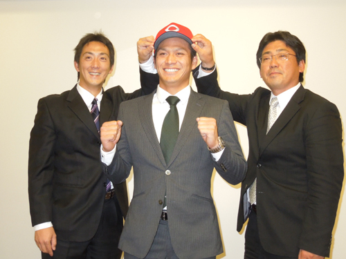 仮契約を終え、広島の球団帽をかぶせてもらう田中（右は高山スカウト、左は尾形スカウト）
