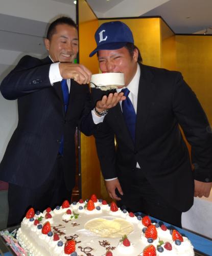 富士大の青木監督（左）に誕生日ケーキを食べさせてもらうドラフト２位の山川
