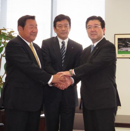 日本ハム・栗山監督（中）は末沢オーナー（右）、竹田球団社長とガッチリ握手