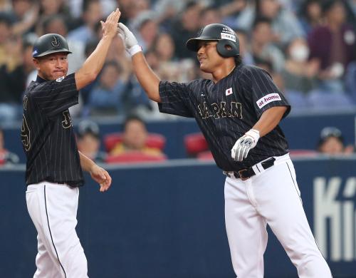 ＜台湾・日本＞９回１死満塁、３点適時三塁打を放ち、大西コーチ（左）とハイタッチをかわす平田