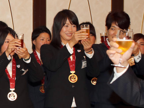 Ｗ杯５連覇を祝い乾杯する川端（中央）らマドンナジャパンの選手たち