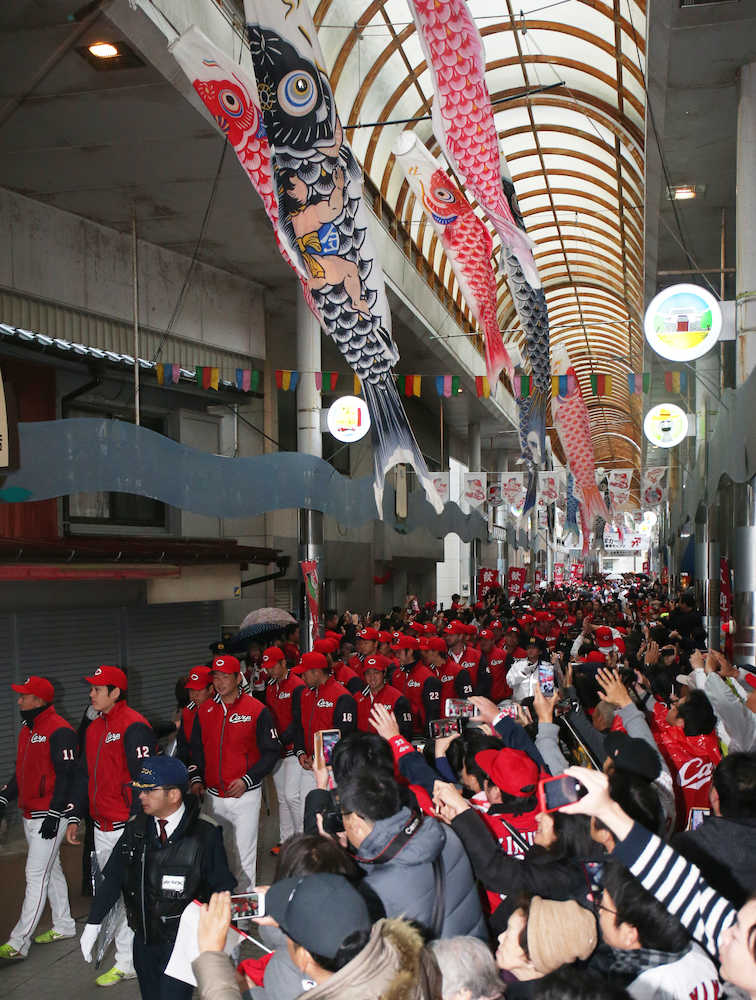 日南市の商店街のアーケードをパレードする広島ナイン