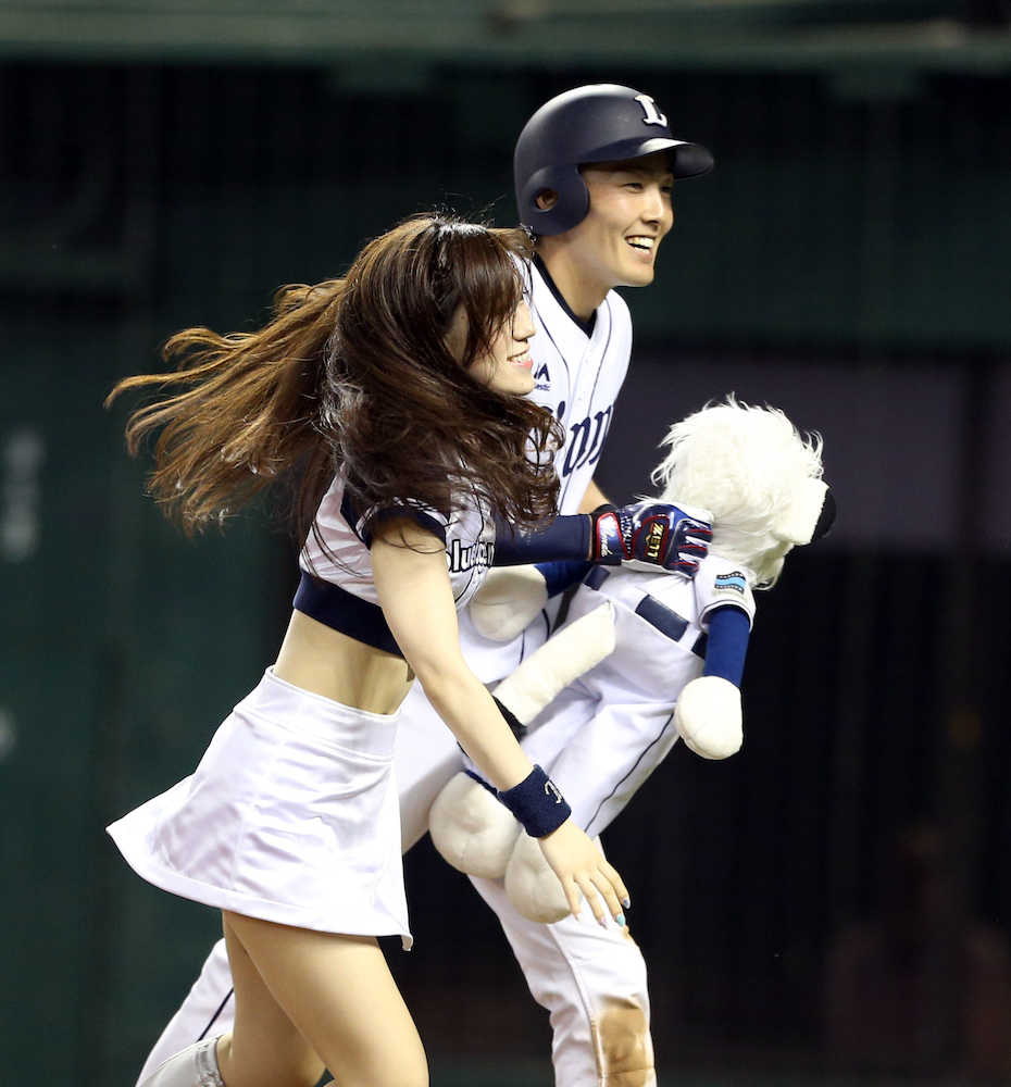 ４回無死二塁　２ランを放ちマスコットガールにレオ人形を手渡される源田（右）　　