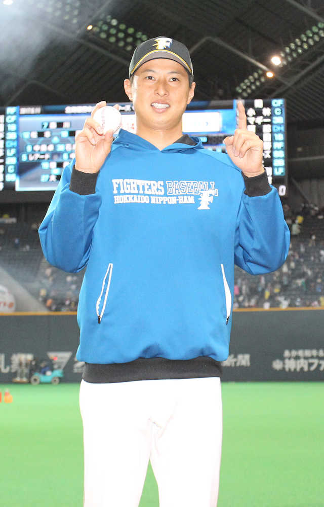 試合後、ウイニングボールを手に「１勝」のポーズをとる村田