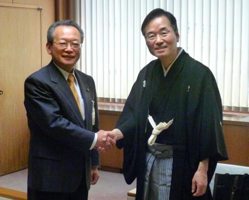 大阪府富田林市役所を訪問し、多田利喜市長（左）と握手をする桂文之助