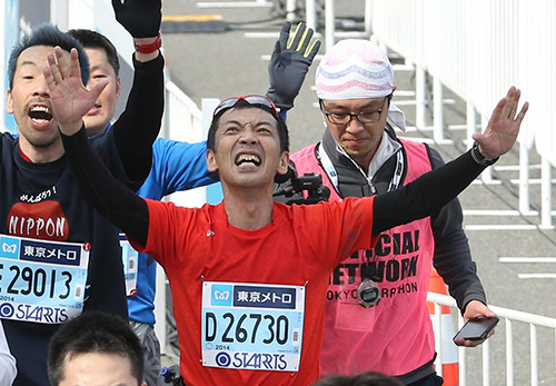 東京マラソンで完走し、両手を広げてゴールする宮根誠司アナ
