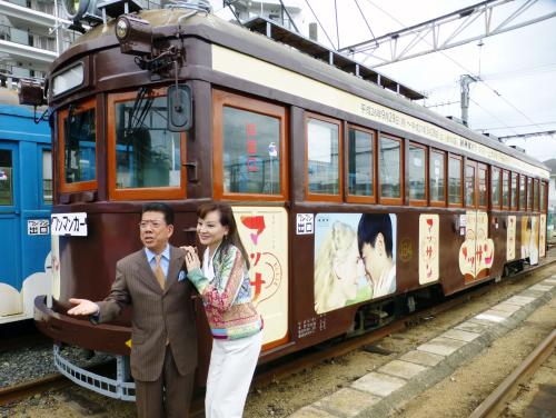 ＮＨＫ連続テレビ小説「マッサン」の番組ロゴをあしらったラッピング電車と出演者の（左から）西川きよし、夏樹陽子