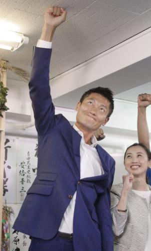 東京選挙区で当選を決め、天井に拳を突き付けて喜びを表す自民党の朝日健太郎氏