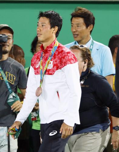 男子シングルスで銅メダルを獲得した錦織圭。右奥は松岡修造さん