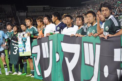 試合後に松田直樹選手の愛称「マツ」と書かれた横断幕を手にする松本山雅イレブン