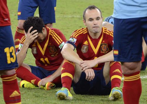 ブラジルに完敗し、座り込むスペインのイニエスタ（右）とペドロ