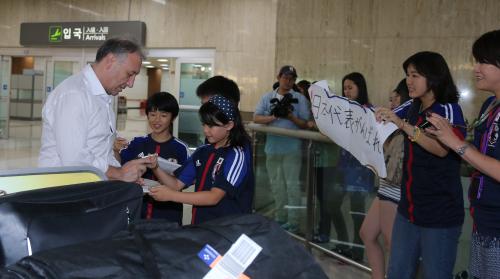 ソウルに到着したザッケローニ監督（左端）が地元の日本人らの声援を受ける