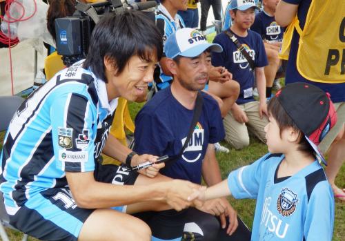 岩手県陸前高田市でサッカー教室などを開催し、子どもと握手する川崎Ｆの中村主将（右）
