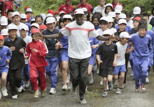 船越小の児童らと仮校舎近くの山道を走るワイナイナさん（中央）