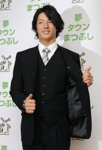 成人式後の記者会見で、式のために選んだスーツを披露する石川遼選手