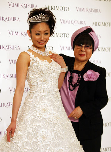 ウエディングドレス姿で登場した安藤美姫（左）とデザイナーの桂由美