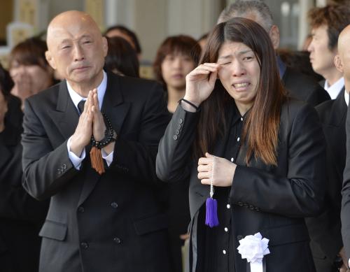 父栄勝さんの告別式で、出棺の際に涙ぐむ吉田沙保里選手。左はレスリング日本女子代表の栄和人監督＝14日午後、津市