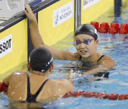 アジア大会女子１００メートル平泳ぎ決勝　１分06秒80で２位となり、４位の鈴木聡美（手前）と握手する渡部香生子