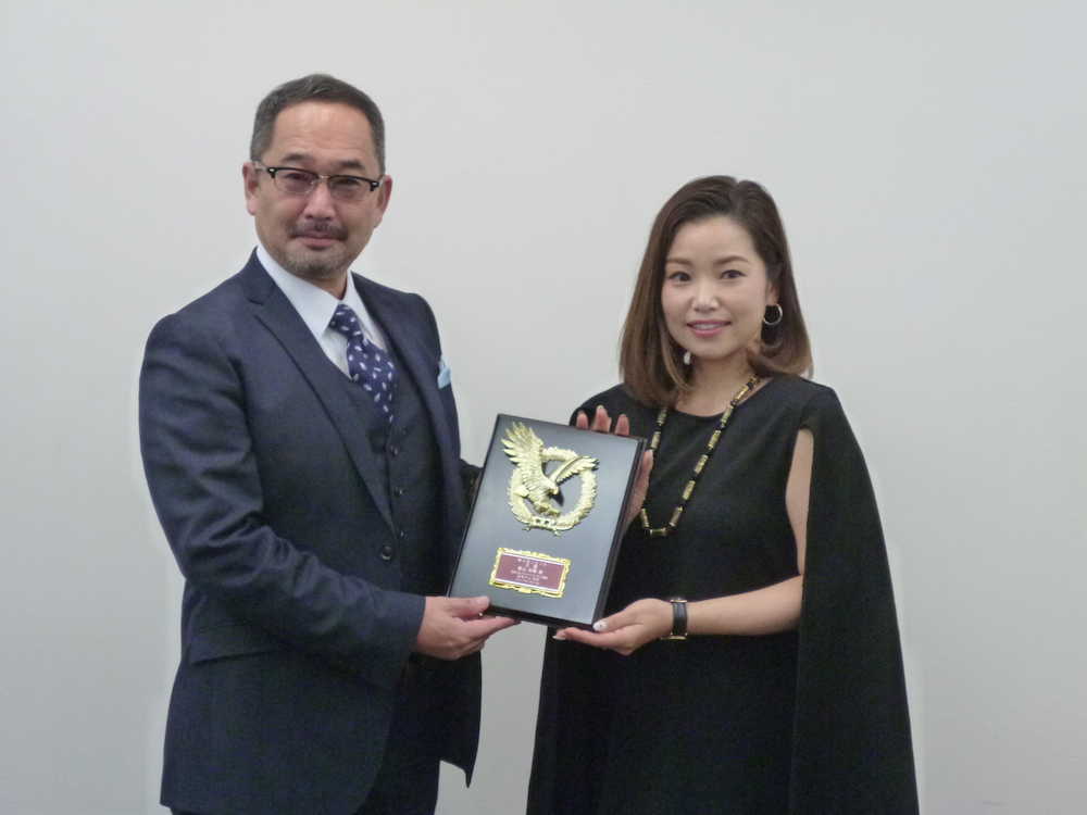 日本ゴルフジャーナリスト協会・片山哲郎会長（左）からＪＧＪＡ大賞の盾を贈られる女子ゴルフの青山加織（右）