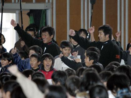 宮崎市内の小学校を訪れ、給食前、体育館に集まった児童ととみにダンスをする巨人・高橋由と脇谷（左）