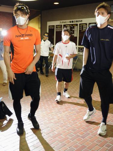 複数選手のインフルエンザ感染が判明し、マスク姿で球場を出る日本ハムの（左から）糸井外野手、谷元投手、林投手