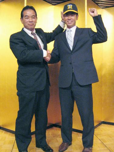阪神への入団に合意し、中尾孝義スカウト（左）と握手する東京ガスの榎田大樹投手
