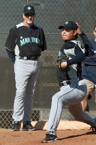 コーチ（左）に見守られ投球練習をするマリナーズ・岩隈