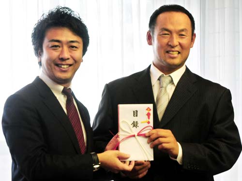 福岡市の高島市長（左）に目録を手渡すソフトバンクの松中