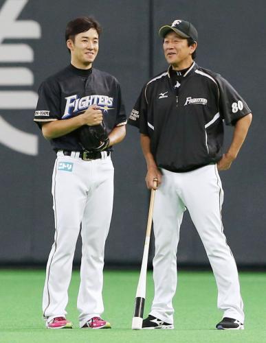 試合前、栗山監督（右）と談笑する日本ハム・斎藤