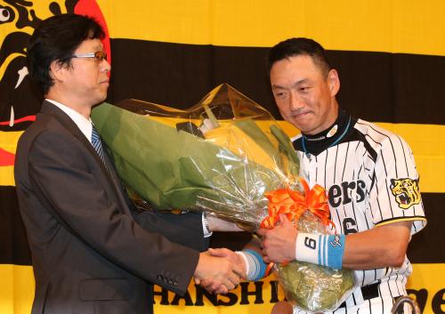 引退会見を終え南球団社長（左）から花束を受け取る阪神・金本