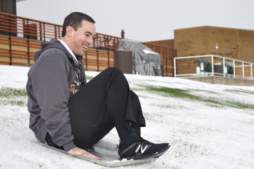 雪に覆われたアリゾナ州のダイヤモンドバックスのキャンプ球場、ソルトリバー・フィールズの左翼芝生席で、そり遊びをする球団職員（ダイヤモンドバックス提供）