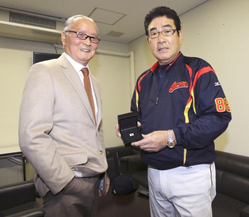 試合前、長嶋茂雄氏（左）から日の丸がデザインされたピンバッジを受け取るＷＢＣ日本代表の山本監督