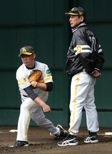 ブルペンで投球する松坂（左）にアドバイスする佐藤コーチ