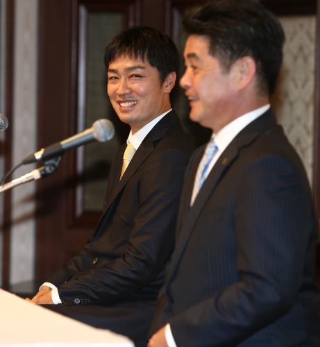 ソフトバンク復帰会見で記者の質問に答える工藤監督（右）を笑顔で見つめる和田