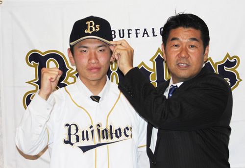 加藤編成部長からオリックスの帽子をかぶせてもらい、緊張気味の吉田凌（左）