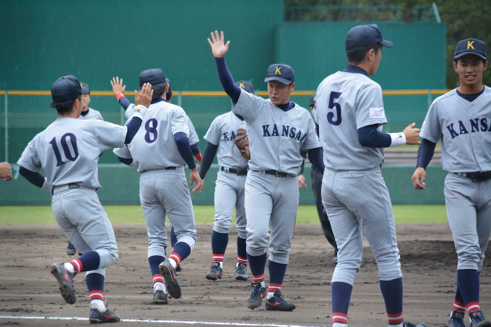 ＜関大・関学大＞関大の阪本大（中央）は完封勝利をマークしチームメートとハイタッチ