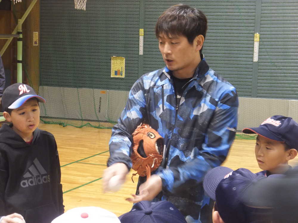 札幌市内の野球教室でボールの握り方を教える涌井