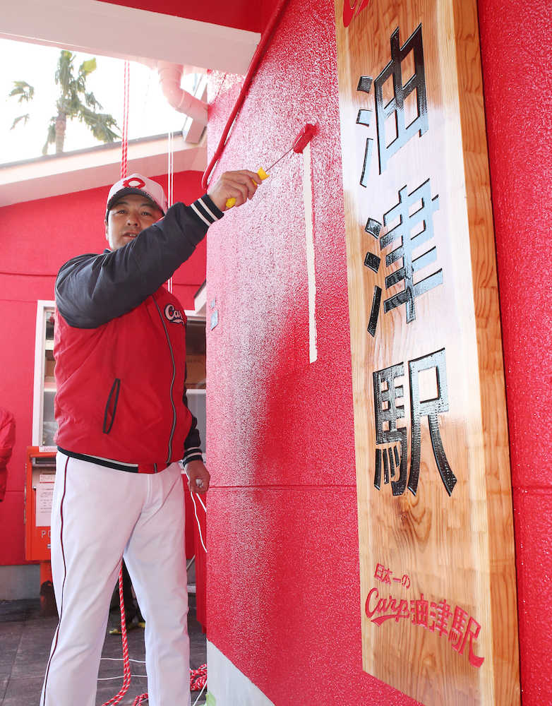 駅舎が真っ赤となるＣａｒｐ油津駅の壁に仕上げのペンキを塗る緒方監督