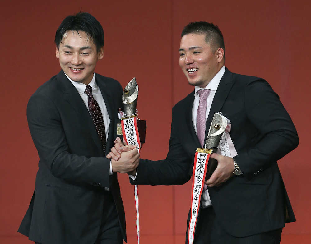 ＭＶＰを受賞し、笑顔で握手を交わす広島・丸（左）と西武・山川＝２７日、東京都内のホテル
