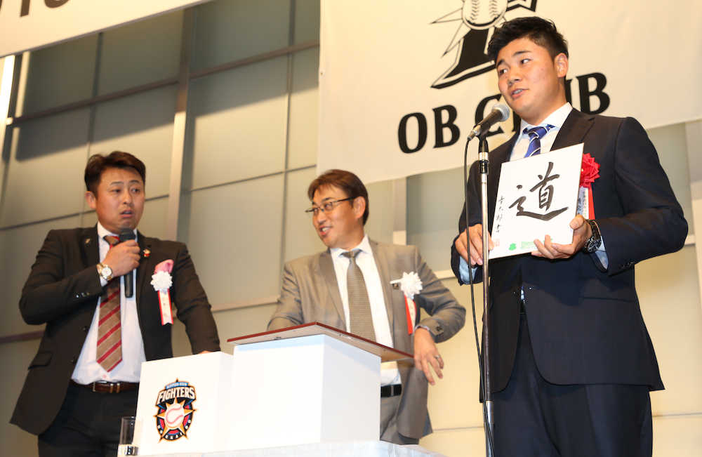 岩本氏（左）、西崎ＯＢ会長（中央）が司会を抽選会で色紙に「道」と書き込みプレゼントする清宮（撮影・荻原　浩人）