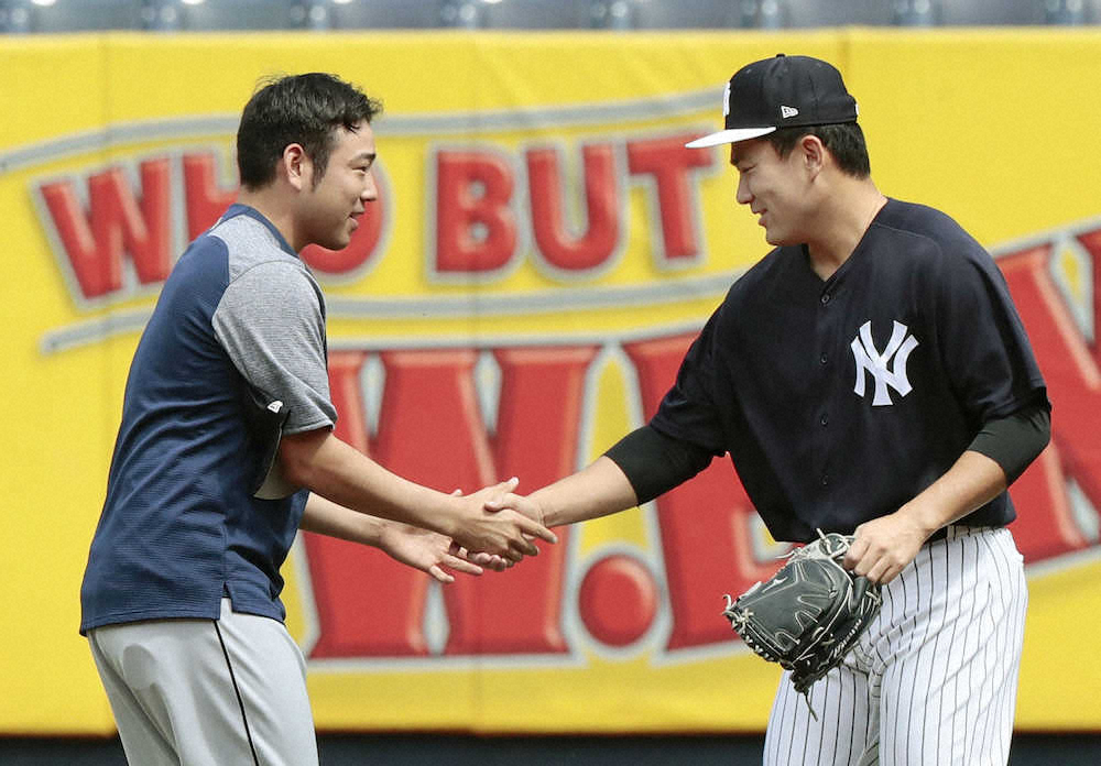 試合前、握手を交わすマリナーズ・菊池（左）とヤンキース・田中