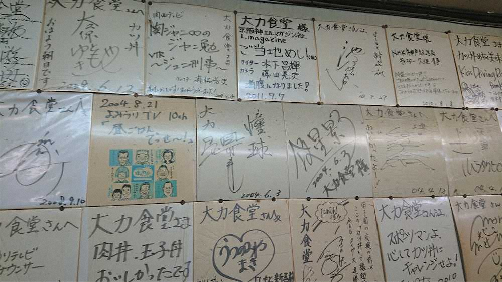 壁一面に掛布雅之氏やタレントのサインが並ぶ