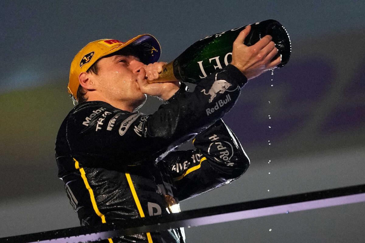 表彰式でシャンパンをラッパ飲みするフェルスタッペン（AP）