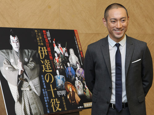 八月花形歌舞伎「伊達の十役」のポスターの前で笑顔を見せる市川海老蔵