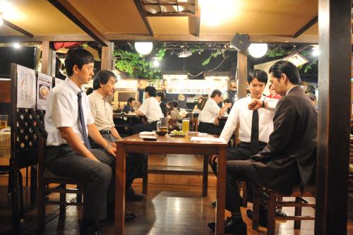 居酒屋で東京中央銀行京橋支店の古里則夫融資課課長代理（右）から不正の決定的証拠をつかみ、追い詰める半沢直樹（右から２人目）。このシーンは「おさかな本舗たいこ茶屋」で撮影された