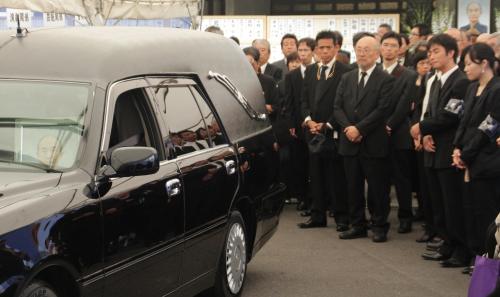 斎藤晴彦さん告別式で、霊きゅう車を見送る参列者たち