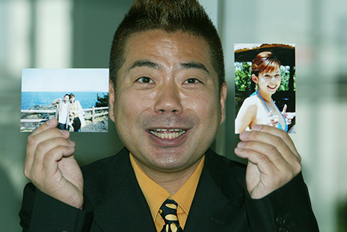 結婚報告会見で妻の写真を両手に、笑顔の出川哲朗