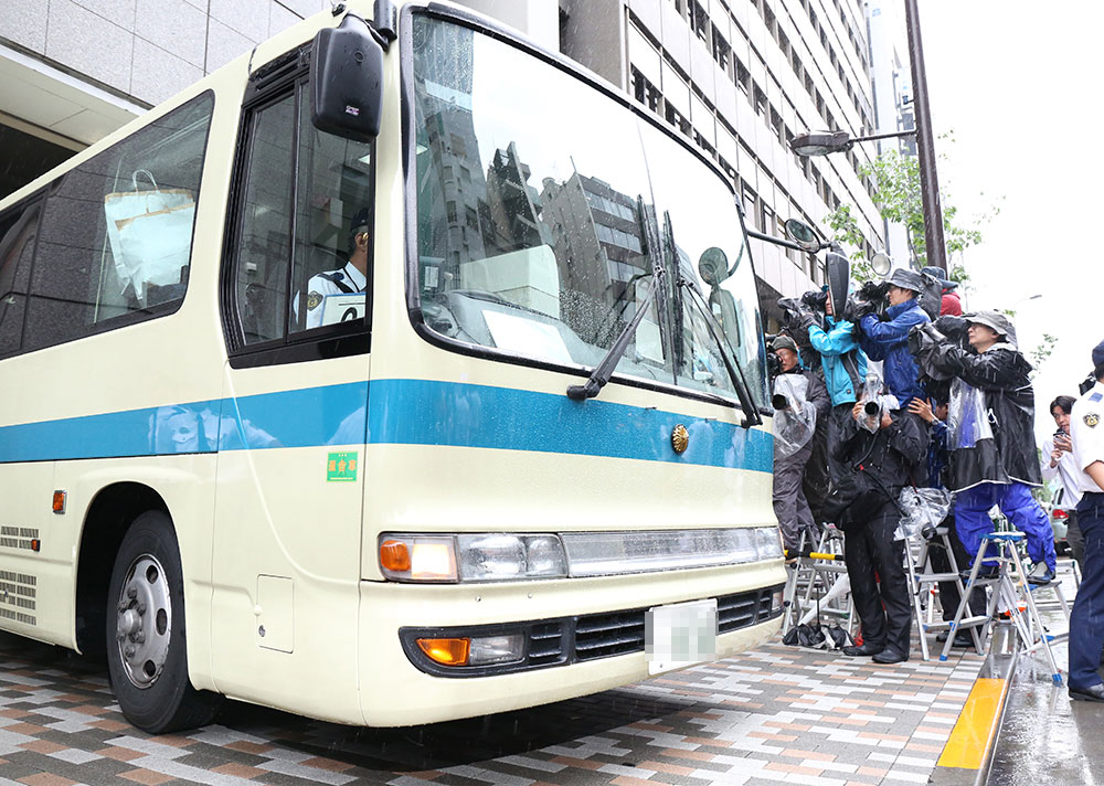 多くの報道陣の前を通り、渋谷警察署から出る田中聖容疑者を乗せたバス