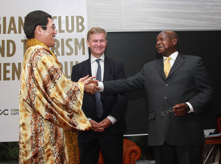 ウガンダのヨウェリ・ムセベニ大統領（右）と握手を交わすピコ太郎（左）。中央は国連のエリック・ソルヘイム環境プログラムエグゼクティブディレクター